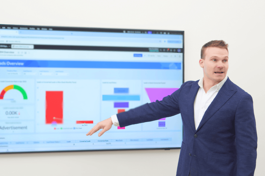Zoho consultant Hugh Marshall standing in front of a screen providing a Zoho product demonstration